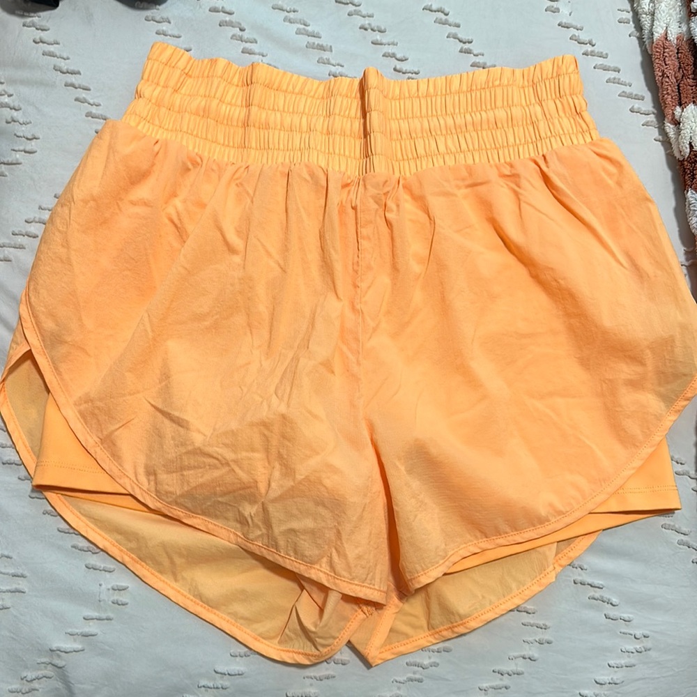 Orange running shorts with built in spandex